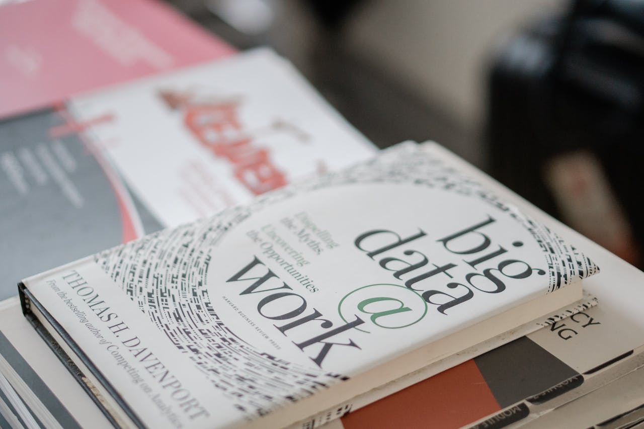 services-img Close-up of books on data analytics and business strategies on a desk.